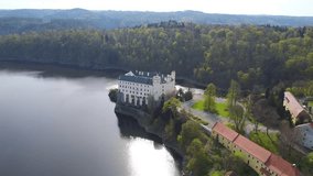Neo-Gothic buildingaerial. View of the castle standing at the foot of the cliff above the water. A unique view of the castle. drone video
