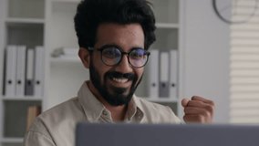 Excited happy Indian Arabian muslim businessman male winner man employee working at home office win laptop celebrate job opportunity online winning business achievement victory finished deal success - Powered by Shutterstock - Get 15% off with code: PIKWIZARD15