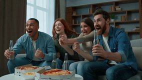 Excited people sport fans watch football at home celebrating win goal soccer match game at living room. Happy diverse women and men supporters watching television scream cheer for victory clink beer - Powered by Shutterstock - Get 15% off with code: PIKWIZARD15