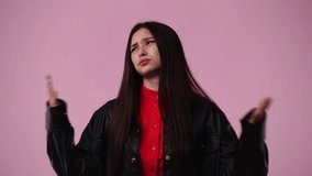 4k video of one girl which tries to cool herself with her hands over pink background.
