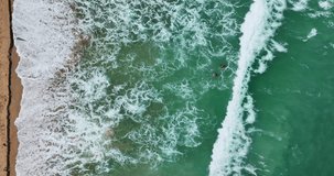 Beautiful sea summer landscape,Big waves crashing on sandy shore, sea water surface High quality video Bird's eye view, Drone top view ocean sea beach waves background