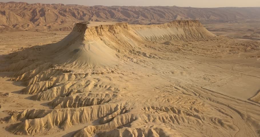 Special Mountain with flat top reveal in the desert in the wild with ridges looking like roots during a summer sunrise with sand clear skies sky, Aerial, Tsin Mountain, Negev Desert, Israel	