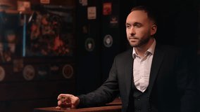 Fashion pensive bearded business man drinking whiskey alcohol at vintage hipster bar counter relaxing alone. Stylish rich brutal male in suit thinking enjoy alcoholic beverage glass illuminated party  - Powered by Shutterstock - Get 15% off with code: PIKWIZARD15