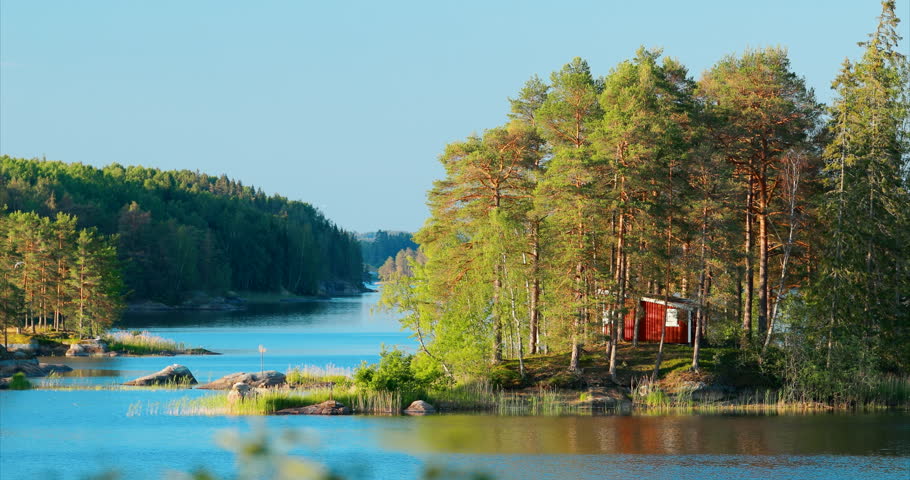 Sweden. Amazing Red Swedish Wooden Log Cabin House On Rocky Island Coast In Summer Sunny Evening. Lake Or River Landscape. Bold Colors. Royalty-Free Stock Footage #1103902679