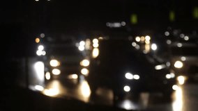Blurred defocused video of evening car traffic in a big city. Cars in motion and standing in traffic jams.