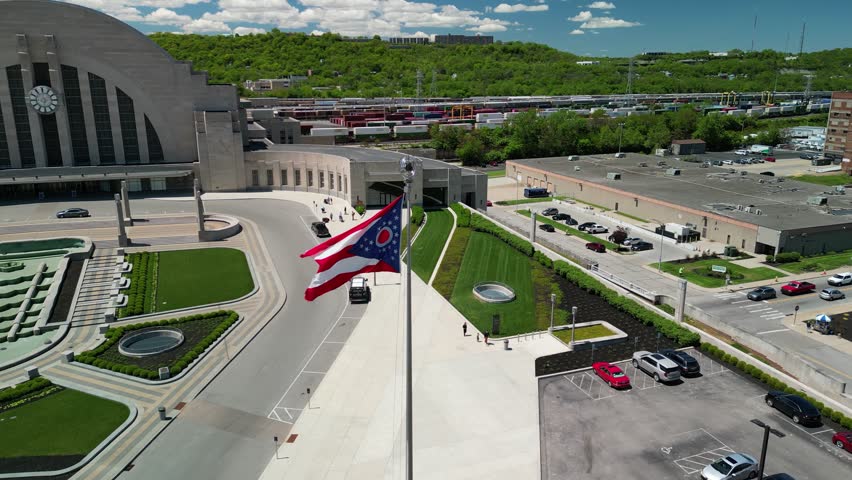 Aerial orbit of flying Ohio Flag and Cincinnati Museum Center Union Terminal