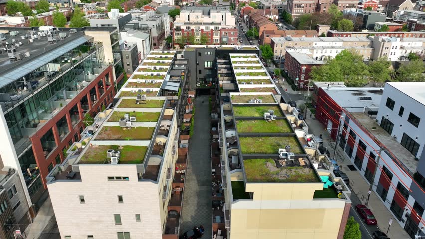 Apartments in American city with green sedum roofs with grass and turf growing to protect our planet. Climate change initiatives in urban housing areas. Aerial establishing shot. Royalty-Free Stock Footage #1103919159