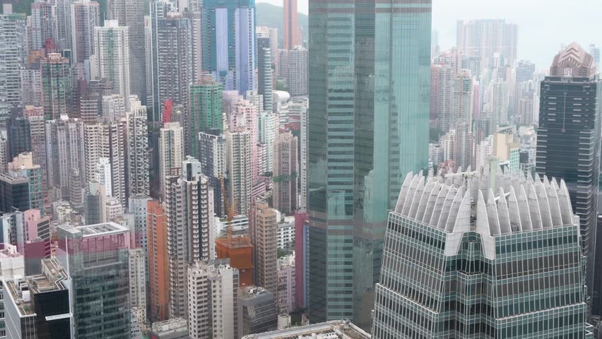 Aerial city view of Hong Kong skyscrapers and office buildings at one of the most densely populated places in the world.