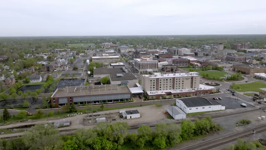 Downtown Muncie, Indiana with drone video moving forward over buildings.