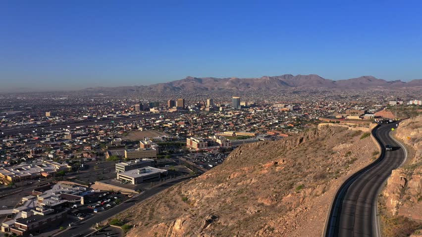 Car Driving on Scenic Drive in El Paso, Texas. Looking at the Cesar E. Chavez Border Highway (375) and Border wall in El Paso, TX before Title 42 Ends. 4k Drone Footage. Royalty-Free Stock Footage #1103924865