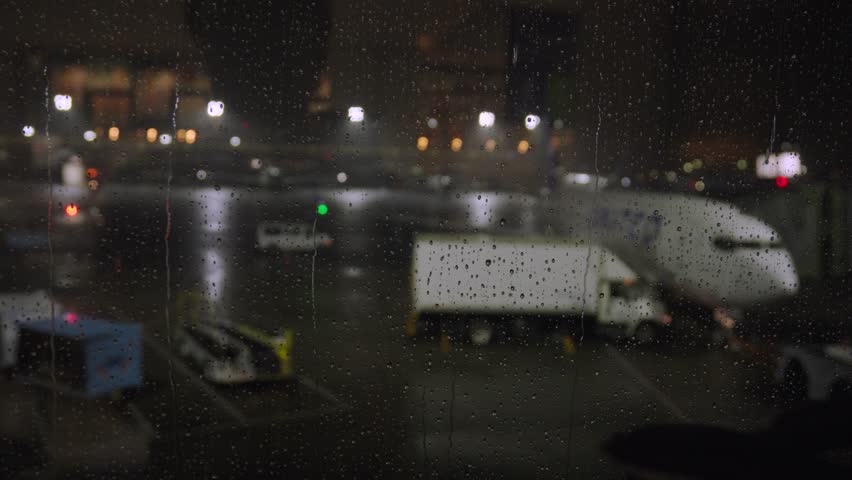 A thunderstorm rages at Newark Liberty International Airport with lightning and torrential rain falling on the tarmac as airplanes sit at their gate and wait for the monsoon to pass.