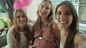 Group of women talking by video call with absent  friend at baby shower. Shot with RED helium camera in 8K.