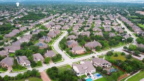 An aerial establishing suburban neighborhood, residential home community Suburb real estate growth. Property prices 4K UHD