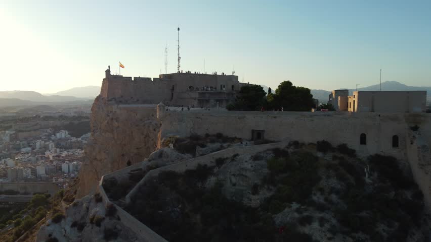 aerial view of Santa Barbara castle with spanish flag in Alicante, Spain