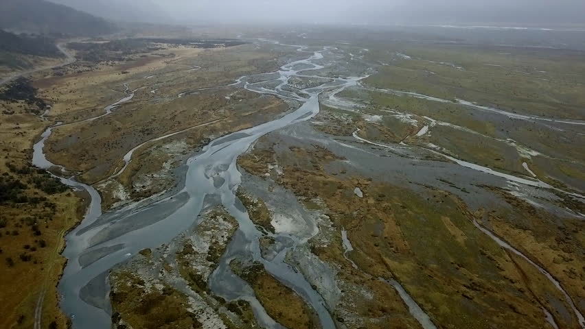 aerial view of the river forms with the autumn vegetation in new zealand. slow motion 