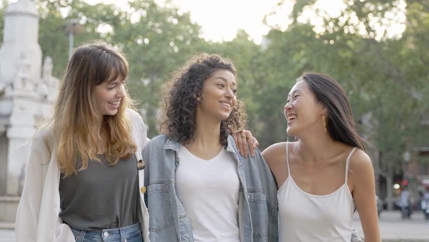 Three young multicultural women having fun on city street outdoors - Mixed race female friends enjoying  summertime vacation together - Friendship concept with happy girls laughing out loud  | Shutterstock HD Video #1103945867