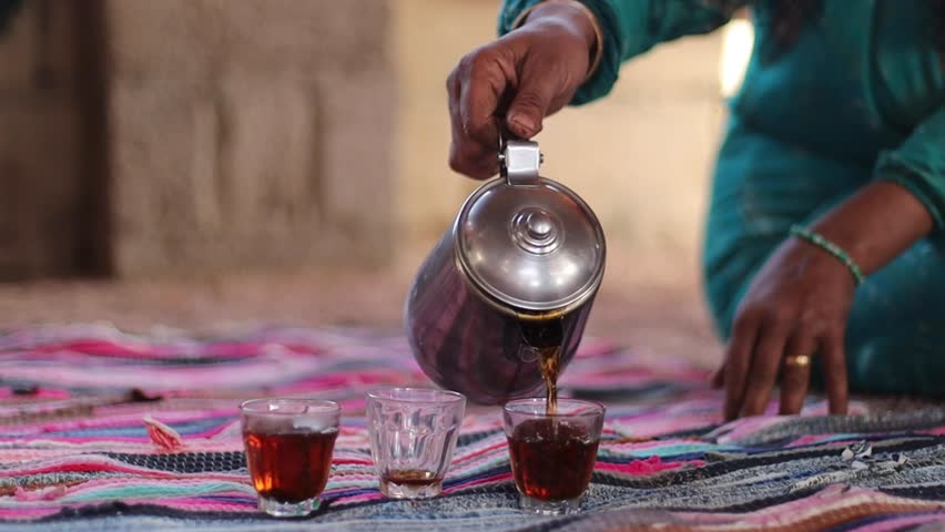 Bedouin chai in the village. Woman serving tea, desert traditional tea in Egypt Royalty-Free Stock Footage #1103948477