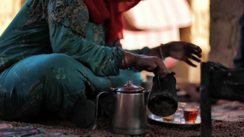 Bedouin woman cooking tea on the fire in Bedouin village, Egypt Royalty-Free Stock Footage #1103948503