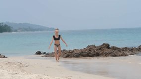 girl doing ring exercise on the beach, gymnastics on vacation, handstand - Powered by Shutterstock - Get 15% off with code: PIKWIZARD15