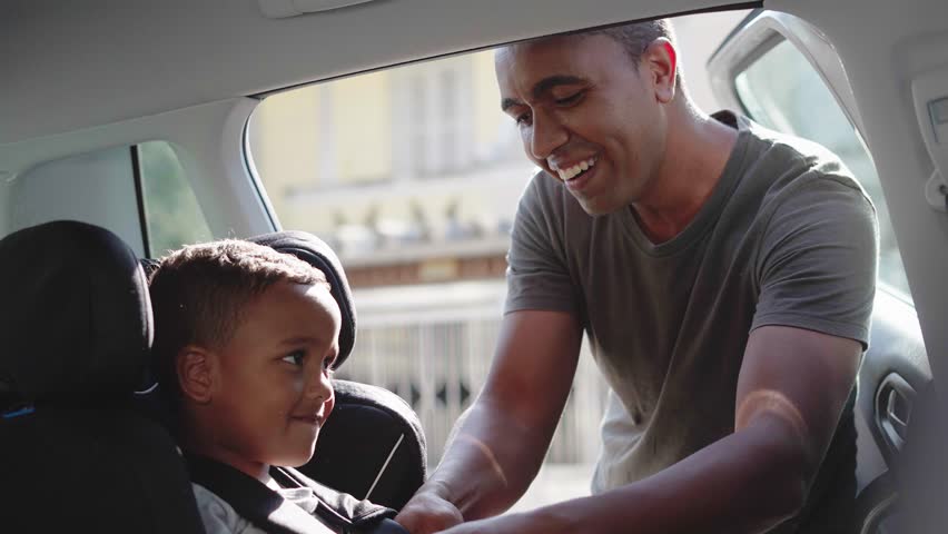 safe ride, loving father puts his little cute male child in back seat in baby car seat and fasten safety belts before driving
 Royalty-Free Stock Footage #1103952261