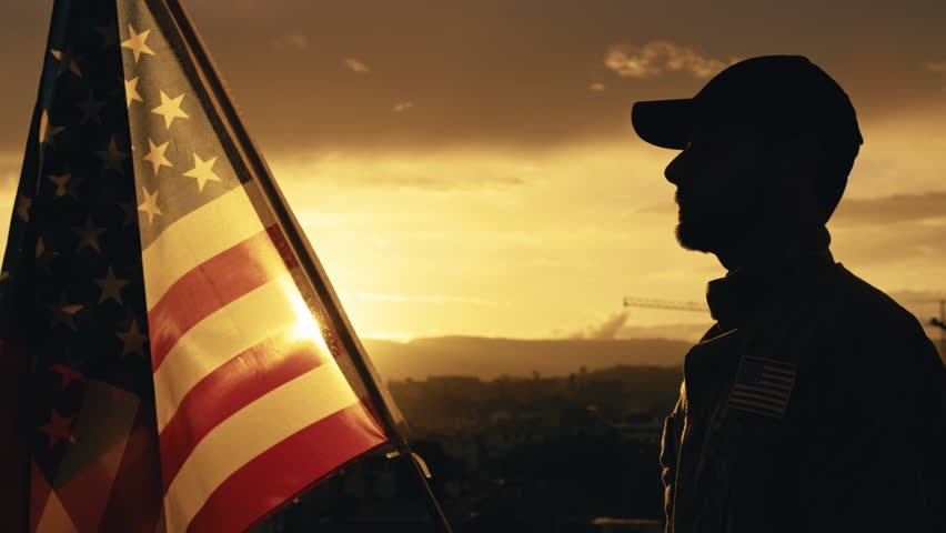 Silhouette of Military Salute of soldier for memorial day against flag at sunset Royalty-Free Stock Footage #1103952493