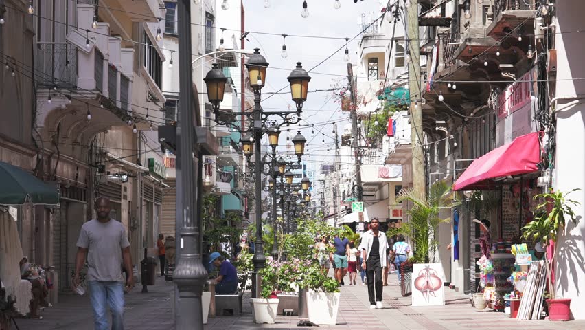 Dominican Republic, Santo Domingo - April 23, 2023: People walk by El Conde street, most popular pedestrian shopping area for tourists and guests of the capital in Colonial Zone
