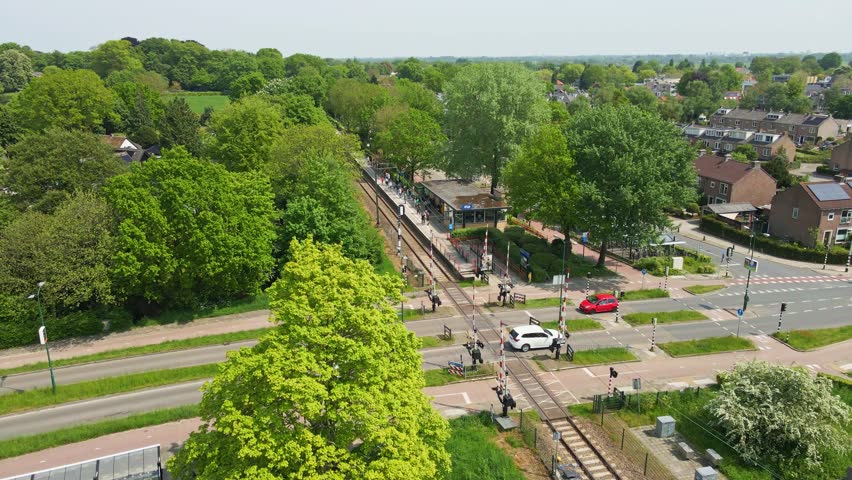 Jib up of a small train station in a small Dutch town Royalty-Free Stock Footage #1103957199
