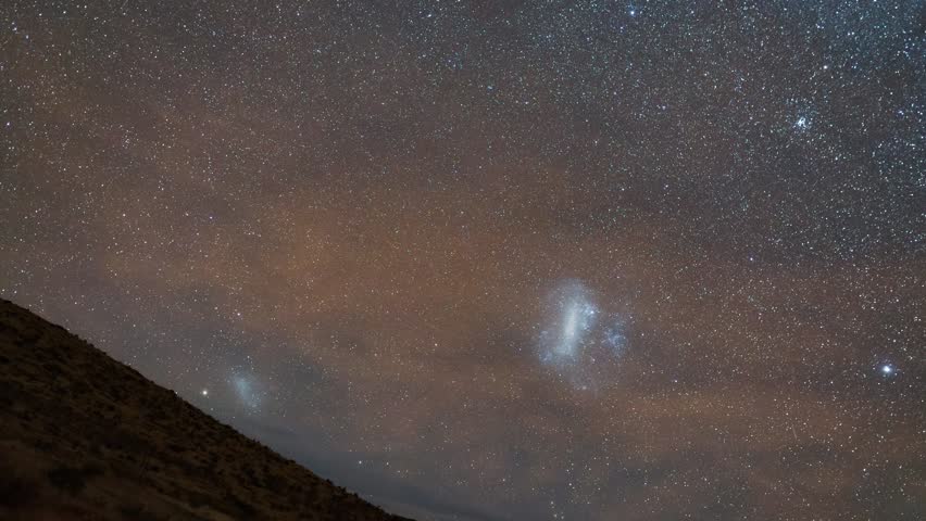Night sky timelapse with tracking taken from Namib desert with Milky Way and Large and Small Magellanic Clouds visible.