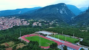 Large sports ground near the Greek town of Litochoro against the backdrop of the Mount Olympus and a cloudy sky
