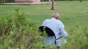 old man isolated sitting alone at iron chair at park from back at evening - Powered by Shutterstock - Get 15% off with code: PIKWIZARD15