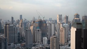 This static view video frames a thriving metropolis landscape, featuring the construction of a new skyscraper nestled among the existing ones. 