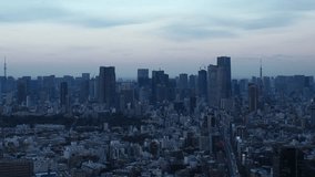 TOKYO, JAPAN : Aerial high angle sunset CITYSCAPE of TOKYO. View of buildings around Roppongi from Shibuya. Time lapse shot, dusk to night. Japanese urban city life and metropolis concept video.