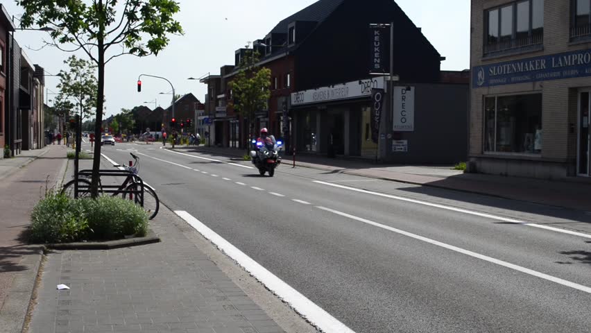 Wilsele, Vlaams-Brabant, Belgium- May 18, 2023: free access to women's local annual cycling race Ladies  Elite. Police motor. Speaker Volvo promotion sponsor car screaming word Rodania while driving