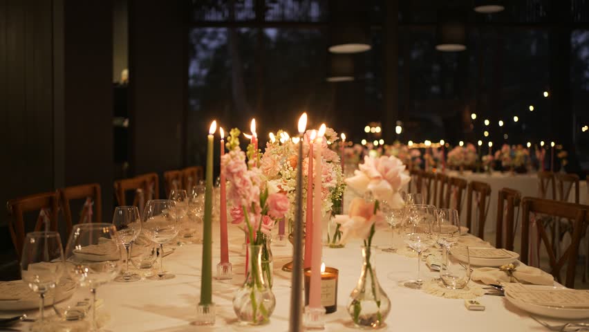 Candles Classy Table Setup Close up Candlelight bright decoration romantic setting table dinner. Wedding decor candle catering dinner luxury event.  Banquet hall interior floristic details Royalty-Free Stock Footage #1103986211