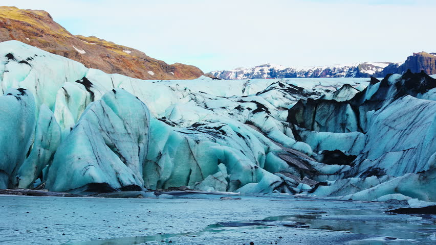 Big vatnajokull glacier mass in iceland next to frozen water in nordic scenery, massive diamond shaped icebergs in cold winter landscape. Natural arctic glacier lagoon and icy blocks.