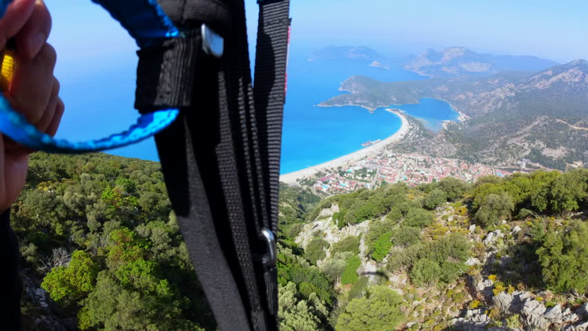 Extreme paragliders flying fast inside the valley of Oludeniz, adventure concept. Royalty-Free Stock Footage #1103987813