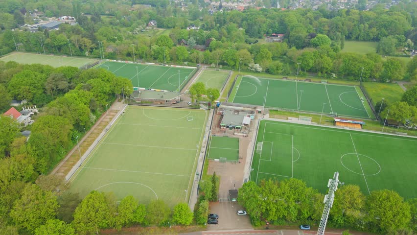 Aerial of multiple soccer fields. Drone slowly flying backwards and ascending Royalty-Free Stock Footage #1103990797