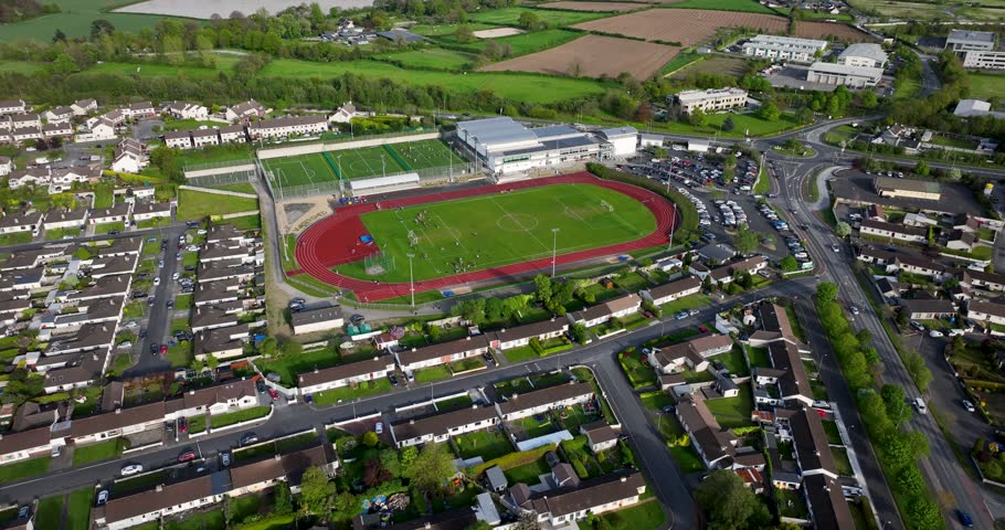A circular flight over a football field in a small town. A beautiful city 5k