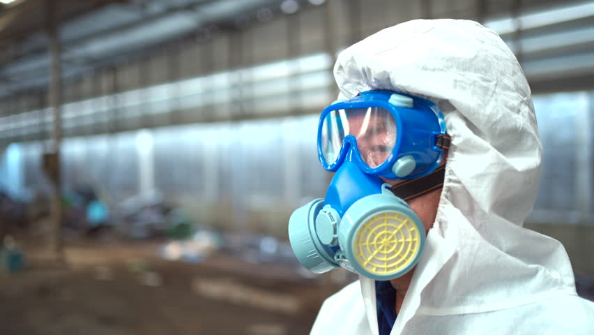 Team of scientist wearing a chemical protection suit and high efficiency filter face mask working in the bio - chemical contaminated factory. Bio chemical scientists working in the hazardous area. Royalty-Free Stock Footage #1104002463