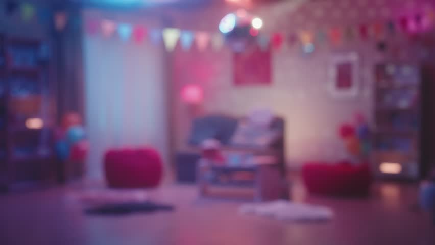 Blurred colorful glow reflecting from a mirrored disco ball inside the room. Defocused interior of a room decorated for a home party or birthday. The concept of entertainment and disco style parties. Royalty-Free Stock Footage #1104004185