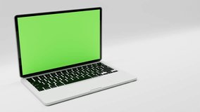 Silver colored laptop video with green screen and mask for easy editing, horizontal position