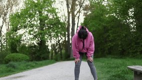 woman running and exercising in park.weight loss concept,after childbirth recovery.get slim fit, dieting.girl in pink hoodie tie laces.people walking in forest with dogs.overweight concept,postpartum 