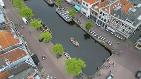 This aerial drone video shows the beautiful old city of Leiden, Zuid-Holland, the Netherlands. In this shot you can see some canals with typical dutch canal houses. 