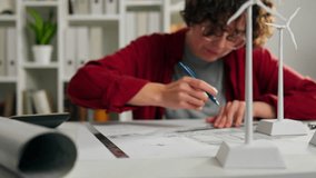 Turbine, business woman working at her desk learning independent energy technology focusing on doing analysis checking building project data design engineering room
 - Powered by Shutterstock - Get 15% off with code: PIKWIZARD15
