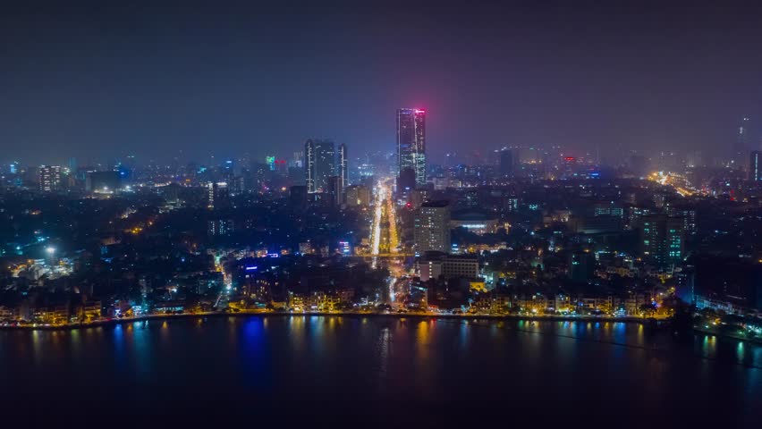 HANOI, VIETNAM - MAY, 2023: Drone aerial timelapse view Vietnam Hanoi downtown city streets from above at night.