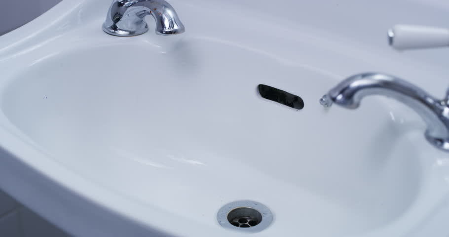 Hands, horror and clean blood in bathroom or crime, violence and cleaning murder evidence or death, criminal and killer. Person, red bloody hand and washing scary gore from disaster or accident