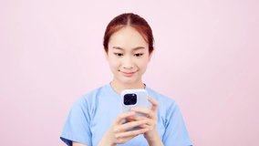 Asian corporate woman in t-shirt looking at smartphone app using mobile
