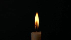 Close-up single candle burning on dark black background, candle fire flame light - Powered by Shutterstock - Get 15% off with code: PIKWIZARD15