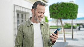 Middle age man dancing listening to music on smartphone at street - Powered by Shutterstock - Get 15% off with code: PIKWIZARD15