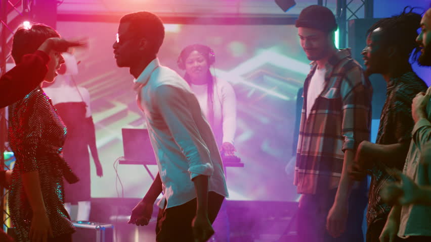 People having fun with dance battle in discotheque, enjoying funny breakdance battle to show off cool moves on dance floor. Young men and women dancing around on electronic music. | Shutterstock HD Video #1104023413